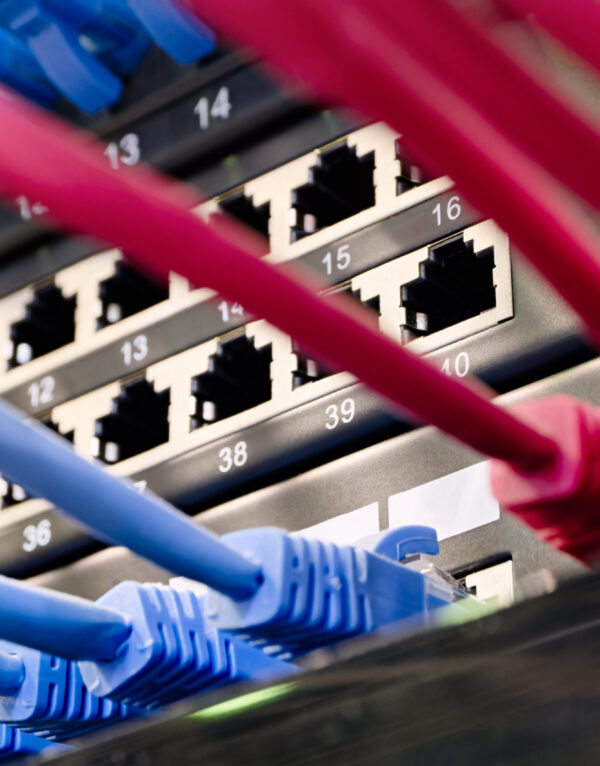 Data center, network panel, switch and connected cables Data center, network panel, switch and connected cables. Close up shot, selective focus, networking technologies background.